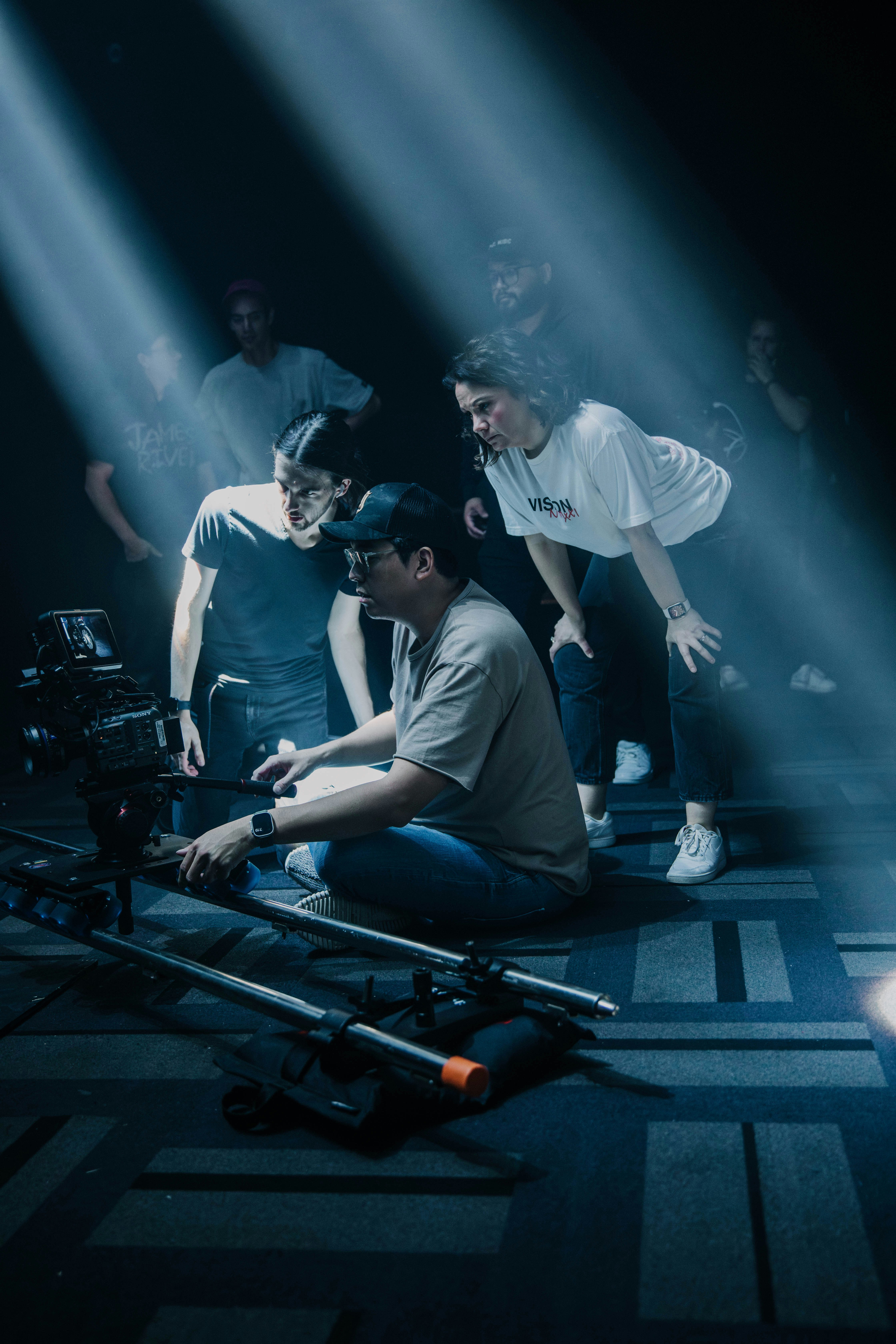 a group of people standing around a camera